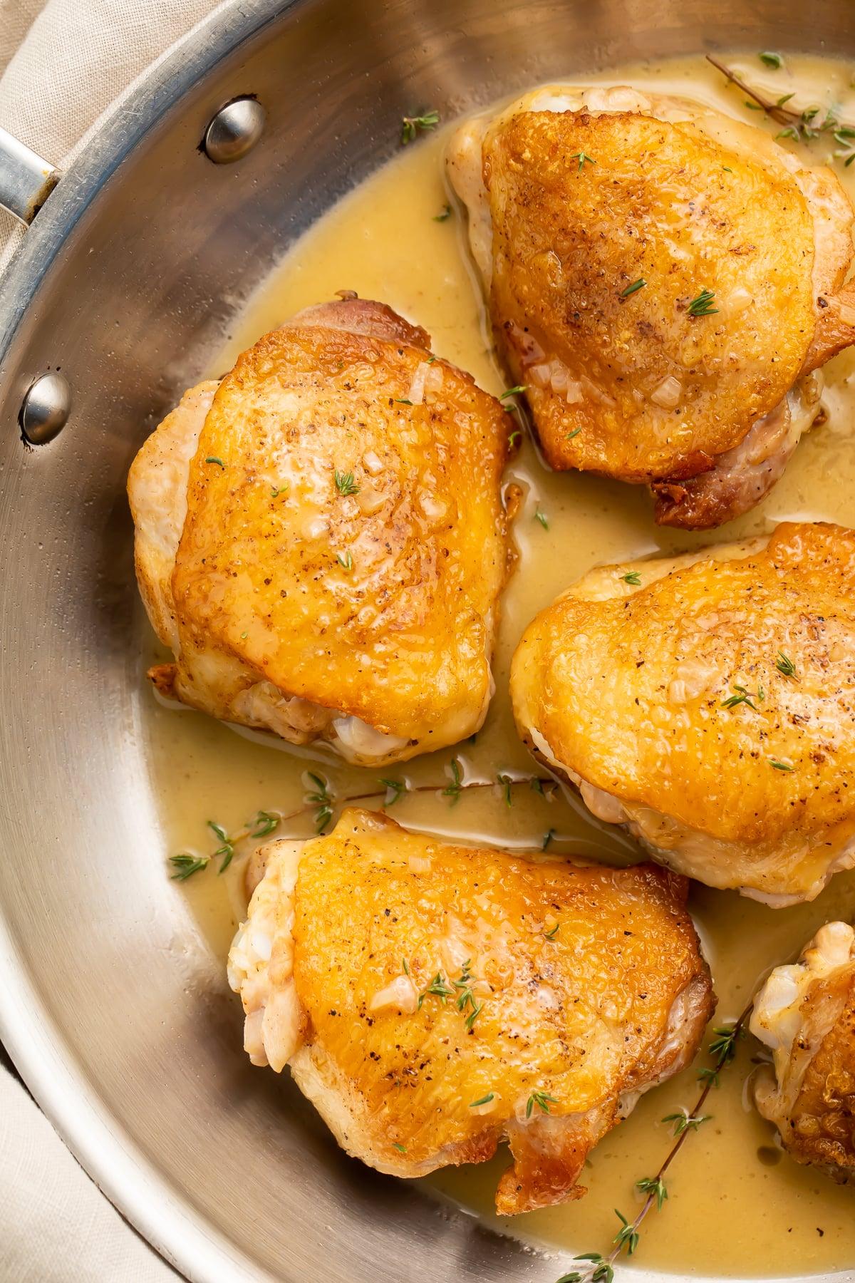 searing chicken thighs in a hot pan