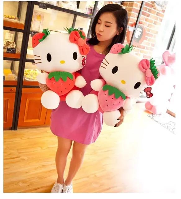 girl happy holding Hello Kitty plushie