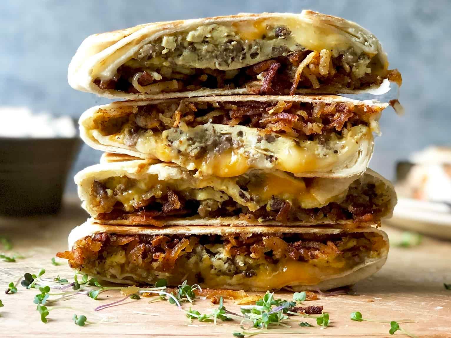 variety of breakfast crunchwraps with different fillings on a serving platter