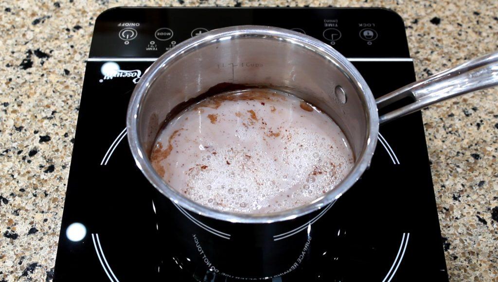 melted chocolate simmering in a saucepan with milk, rich texture