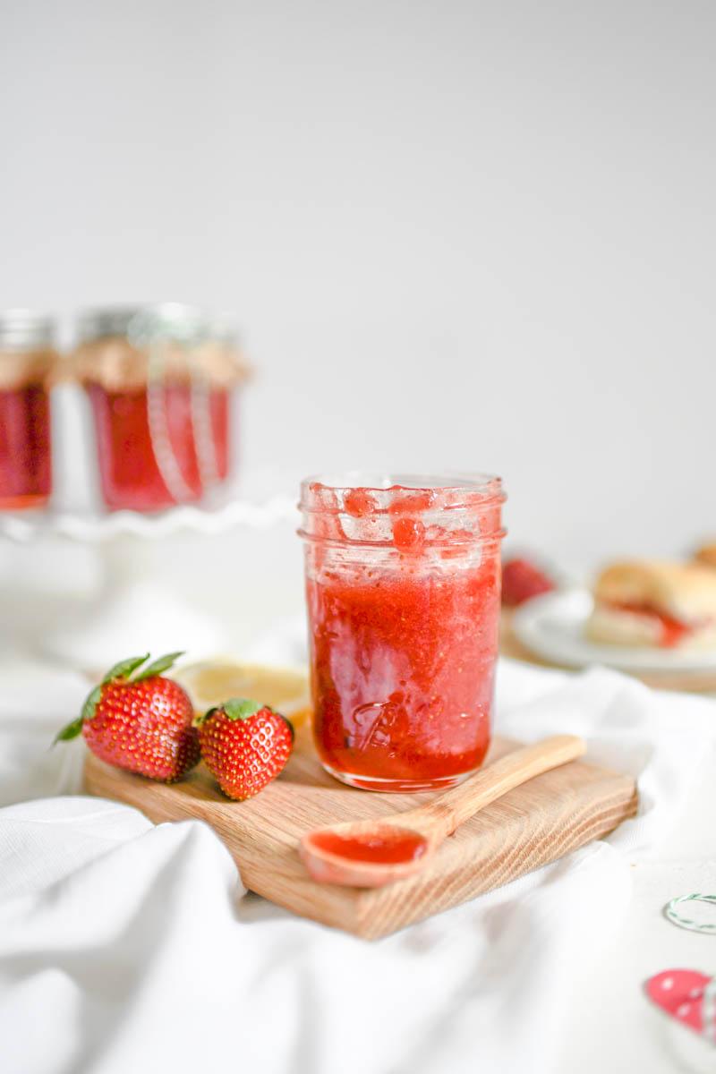 assortment of breakfast foods with a jar of strawberry lemonade preserves in the middle