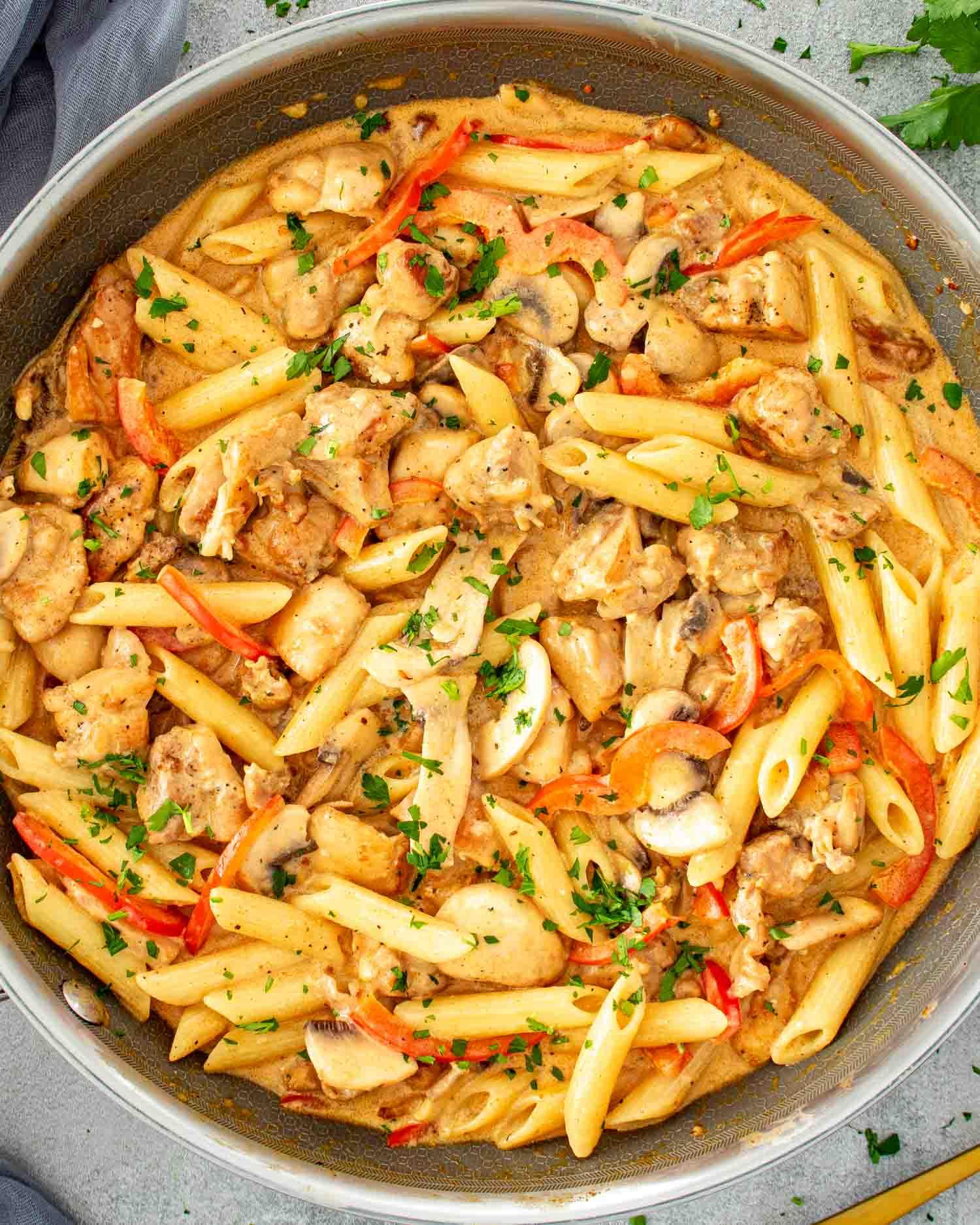 Comforting bowl of creamy Cajun chicken pasta on a rustic kitchen counter