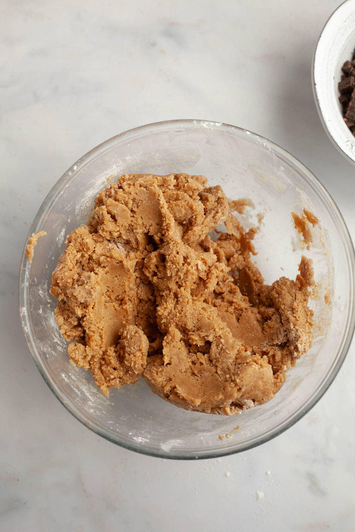 cookie dough with brown butter mixed in, in a glass bowl