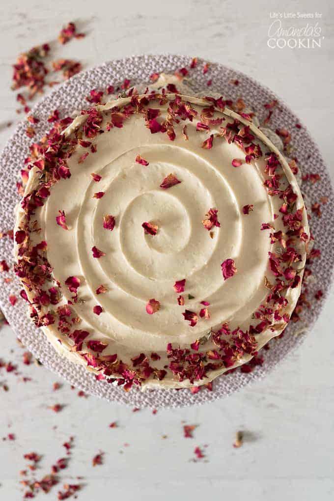 Overhead shot of a beautifully decorated Crimson Velvet Sunrise Cake on a cake stand