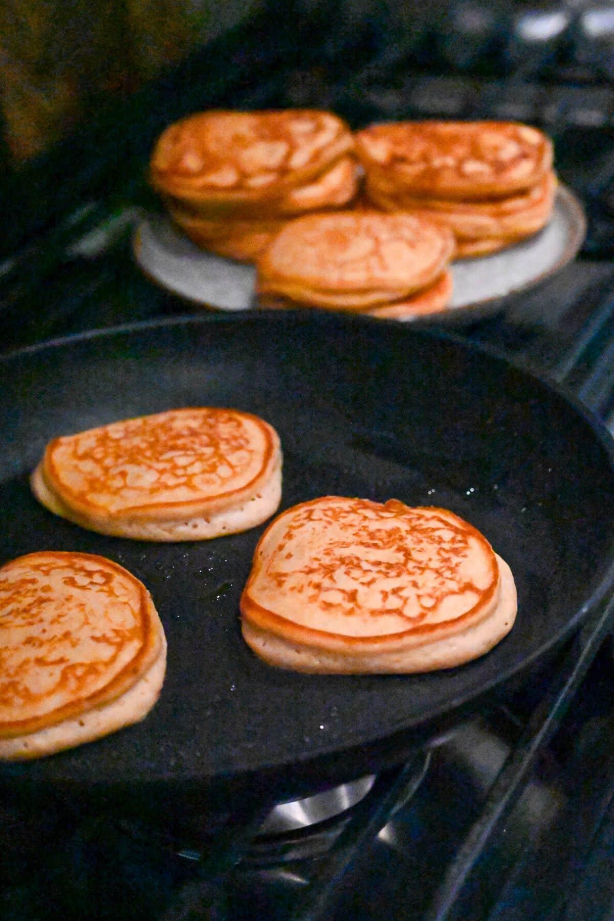close up of sweet potato pancake batter being poured onto a griddle