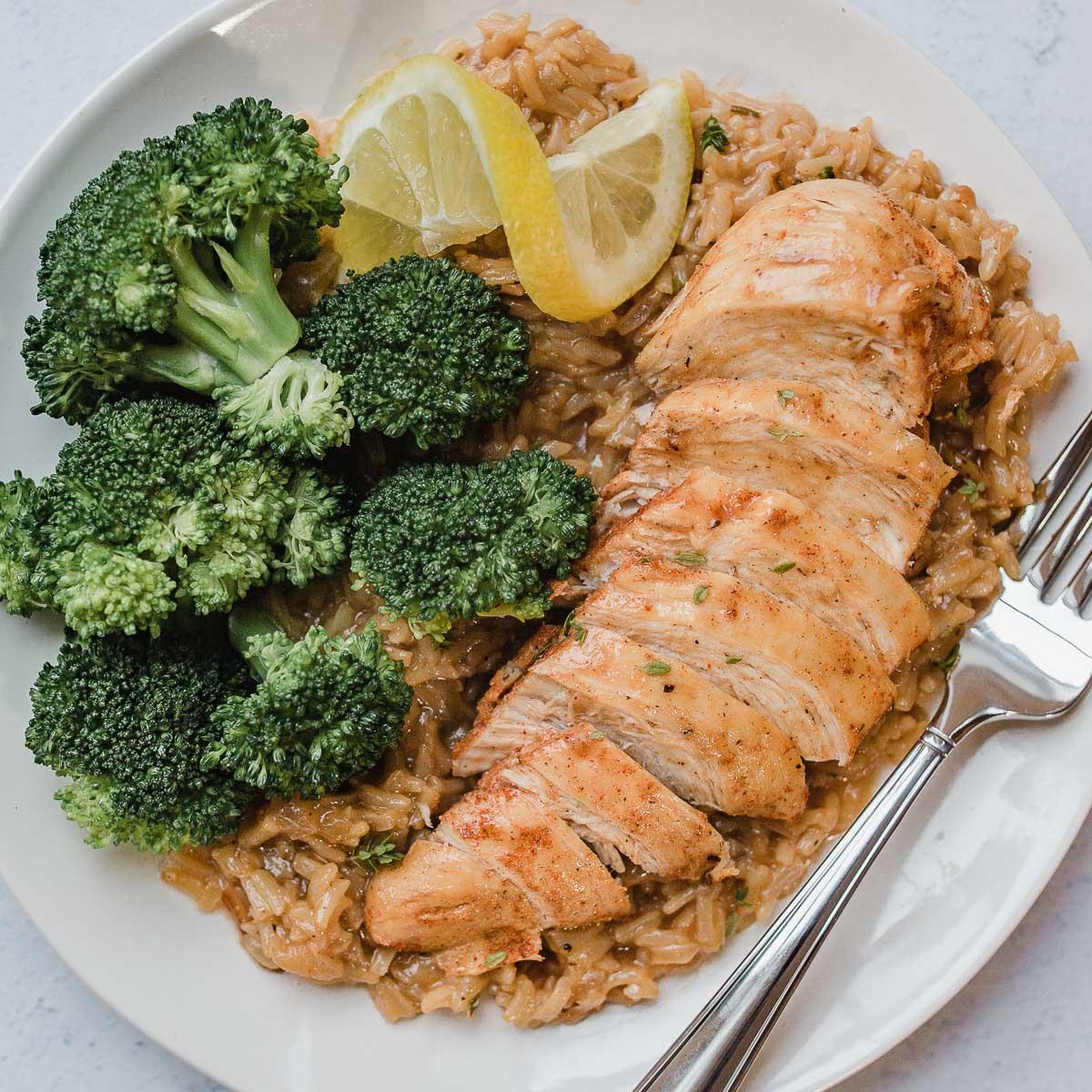 overhead shot of a golden brown lemon herb chicken and rice baking dish