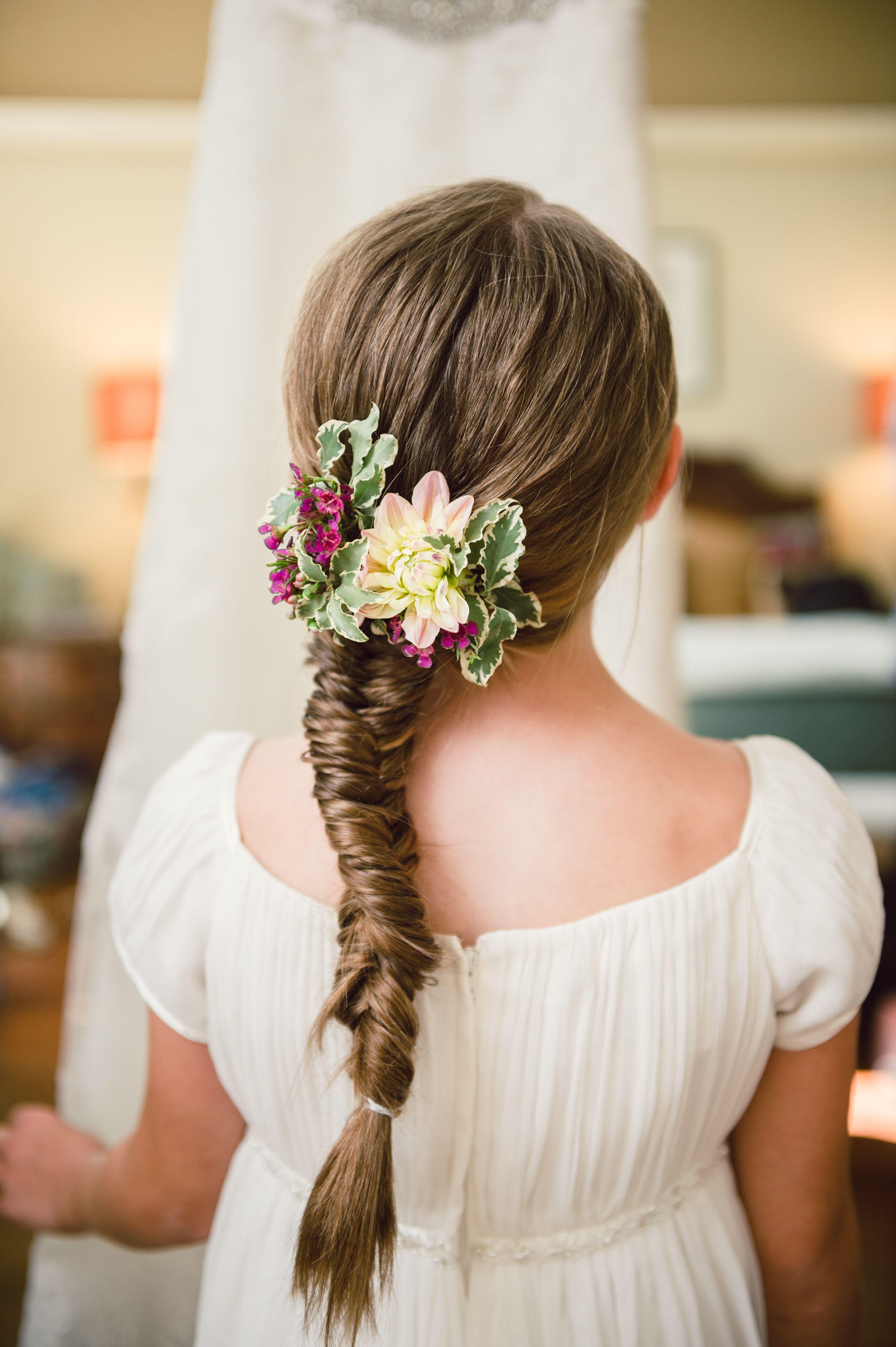 woman with a fishtail braid in a flower garden