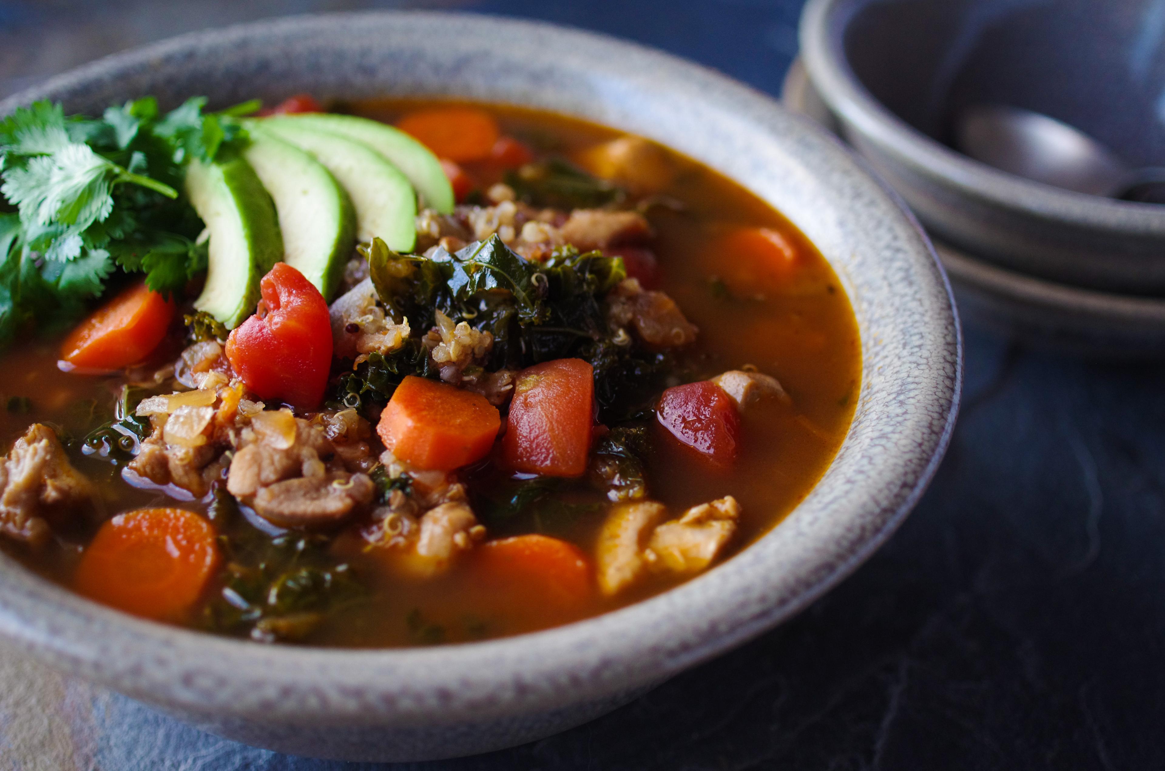 bowl of star anise chicken quinoa stew garnished with cilantro