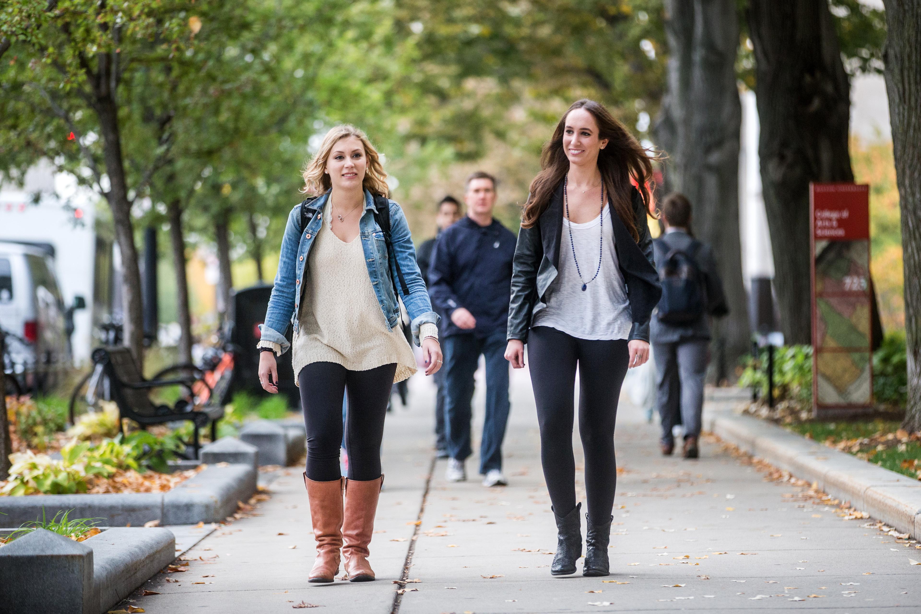 students walking on campus wearing leggings and yoga pants