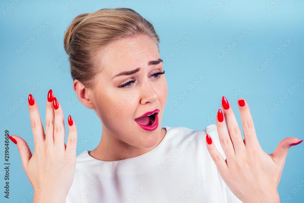 woman looking frustrated at her chipped nails
