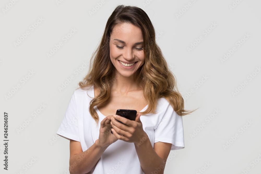 teen smiling while using social media on phone