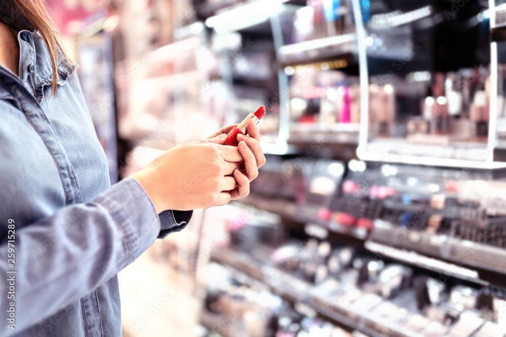 woman looking at makeup at the drugstore
