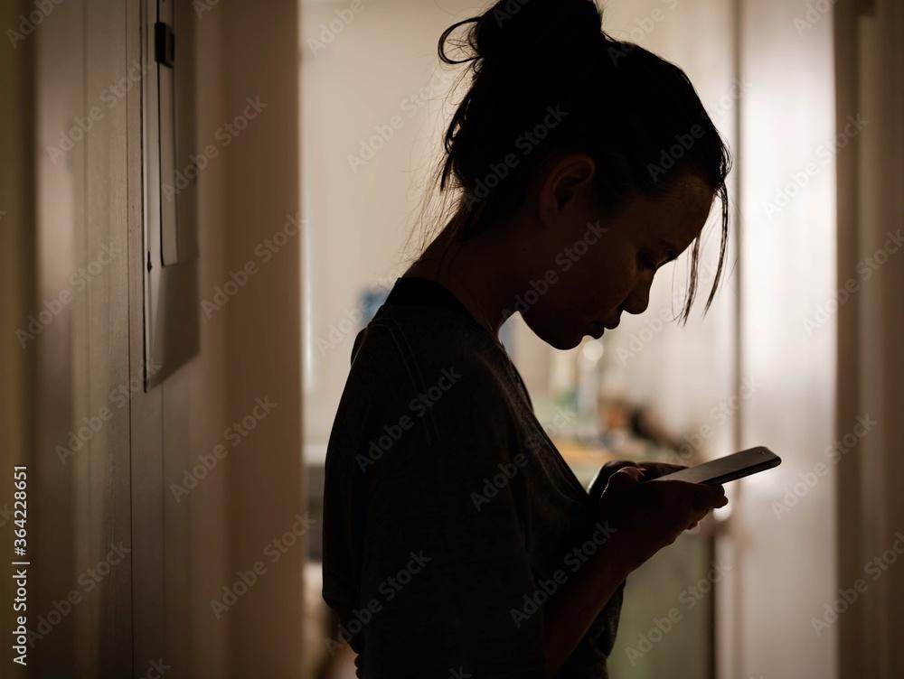 woman looking stressed at her phone