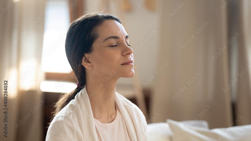 close up of a person practicing mindful breathing with eyes closed