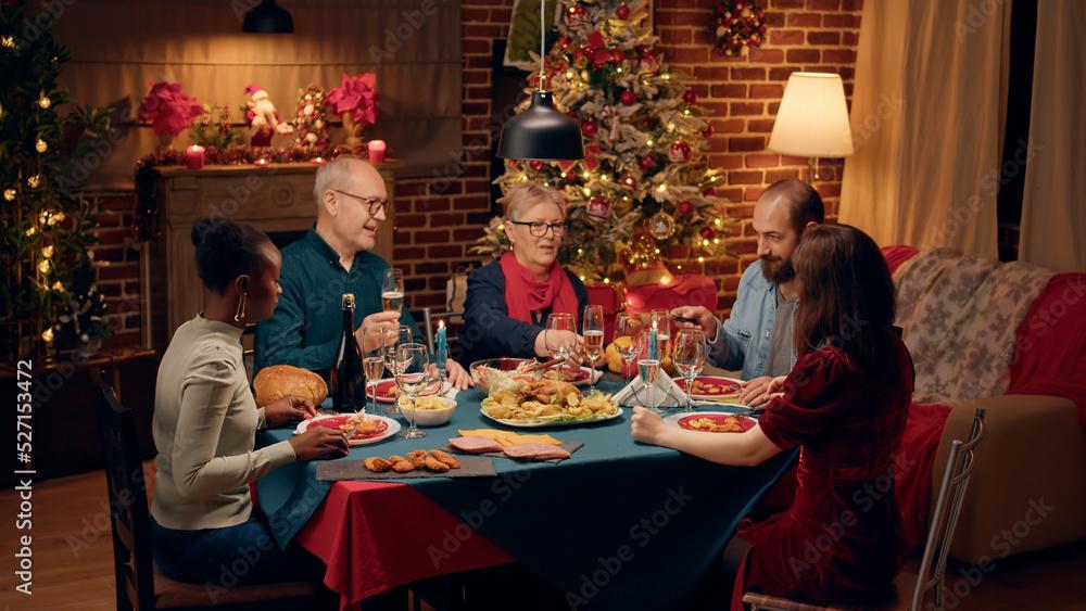 family laughing around a holiday table with a pitcher of ruby sangria, soft focus background