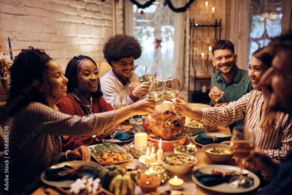 group of friends toasting with sparkling cranberry drinks during a Friendsgiving dinner