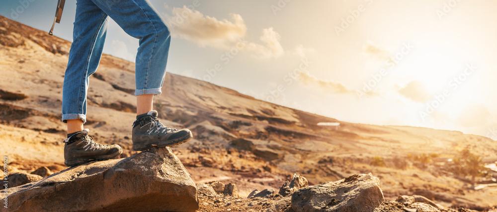 hiking shoes on a rocky trail with mountain backdrop