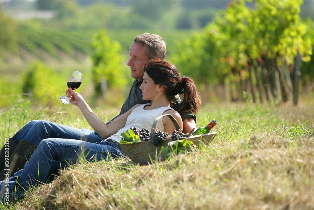 Couple enjoying wine in a vineyard