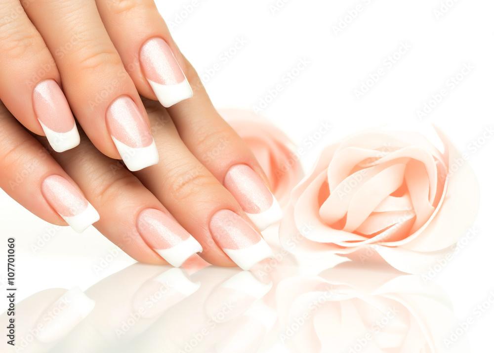 Close up of a woman's hands with beautiful gel French tip nails