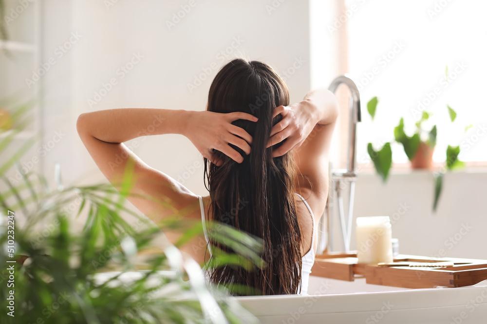 Woman applying hair oil