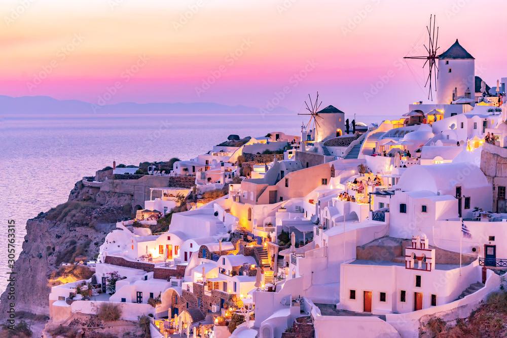 Santorini sunset with white buildings in background