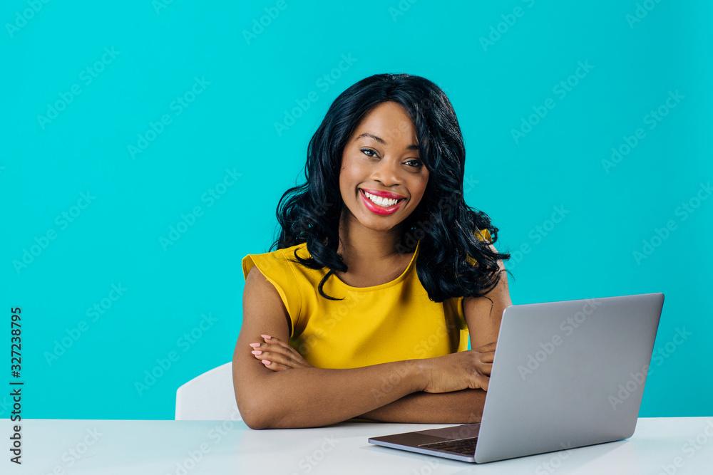 Woman smiling and looking at laptop