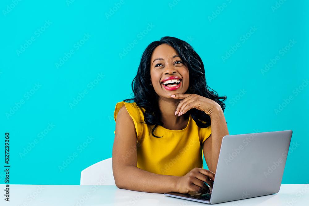 woman smiling happily using a laptop