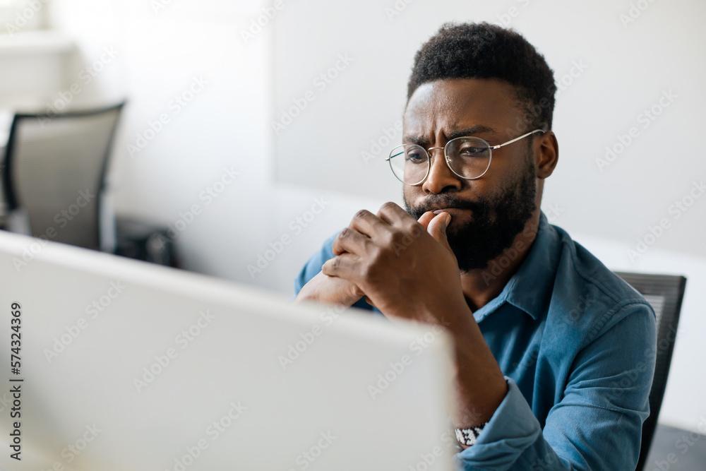 person looking thoughtfully at a screen