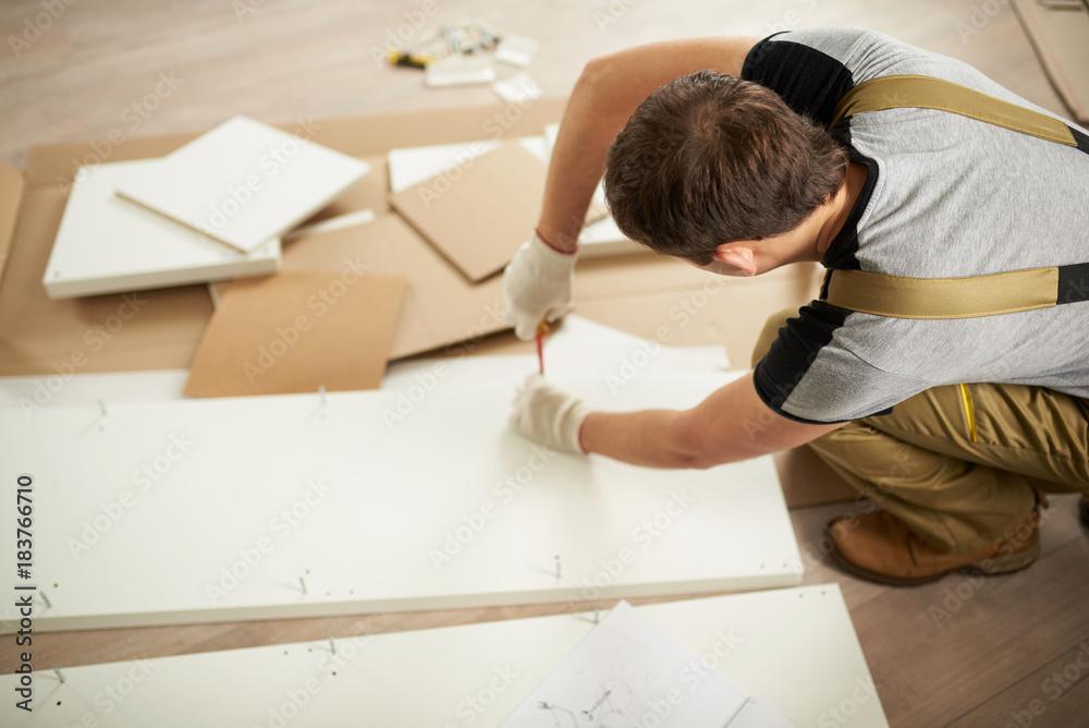 person assembling a poster