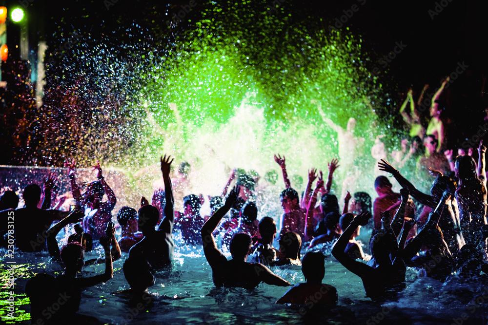people partying by a pool at night