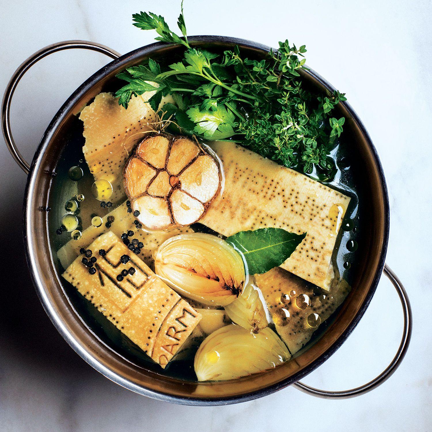 parmesan cheese rinds simmering in a pot of broth, close-up
