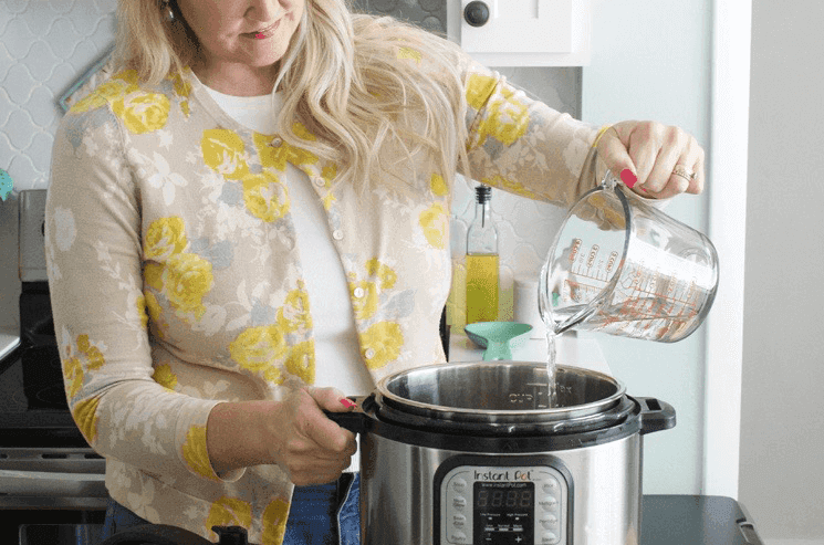 woman deciding between instant pot and slow cooker
