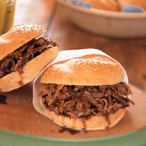 shredded pork being tossed with mint-lime BBQ sauce