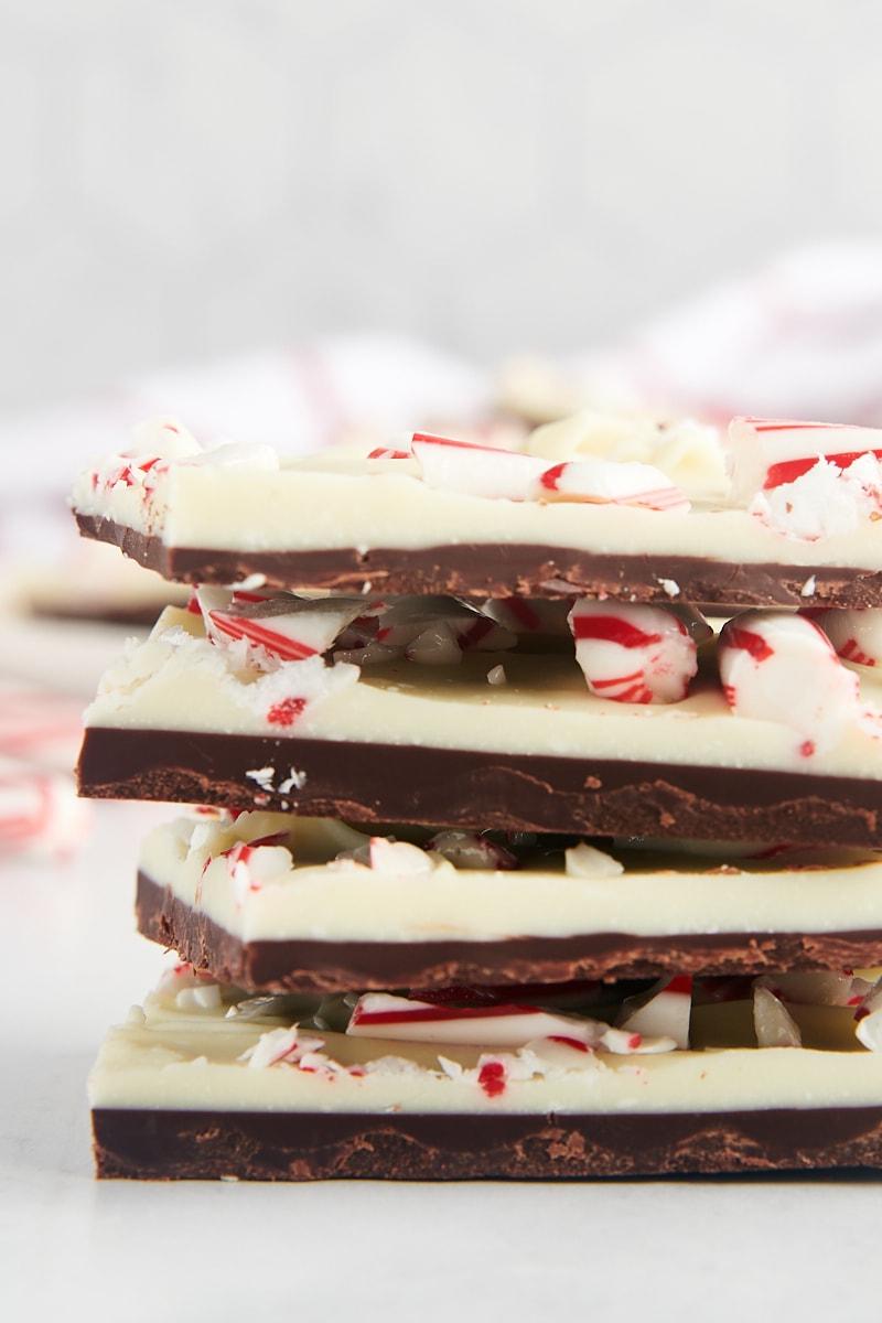 Close-up of peppermint bark squares stacked, showing crisp edges