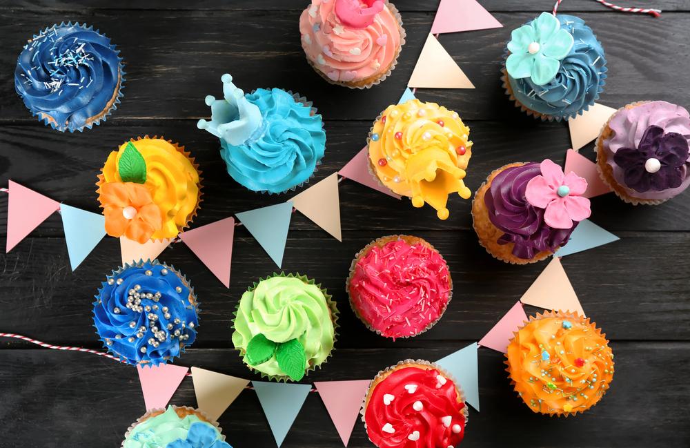 A person taking a bite of a honey lavender mini-cupcake, with a happy expression