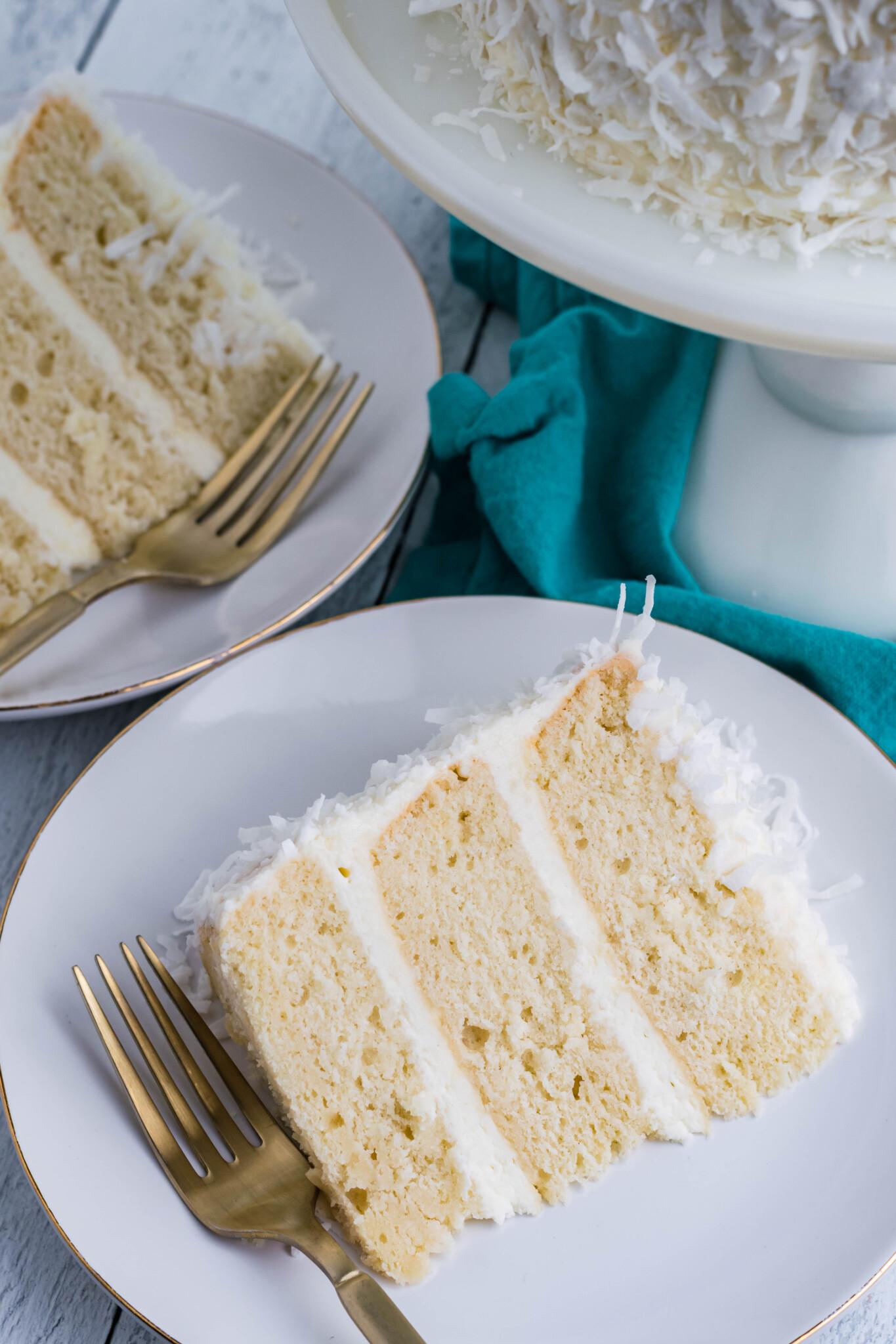 Overhead shot of a beautifully frosted vanilla cake with coconut shavings