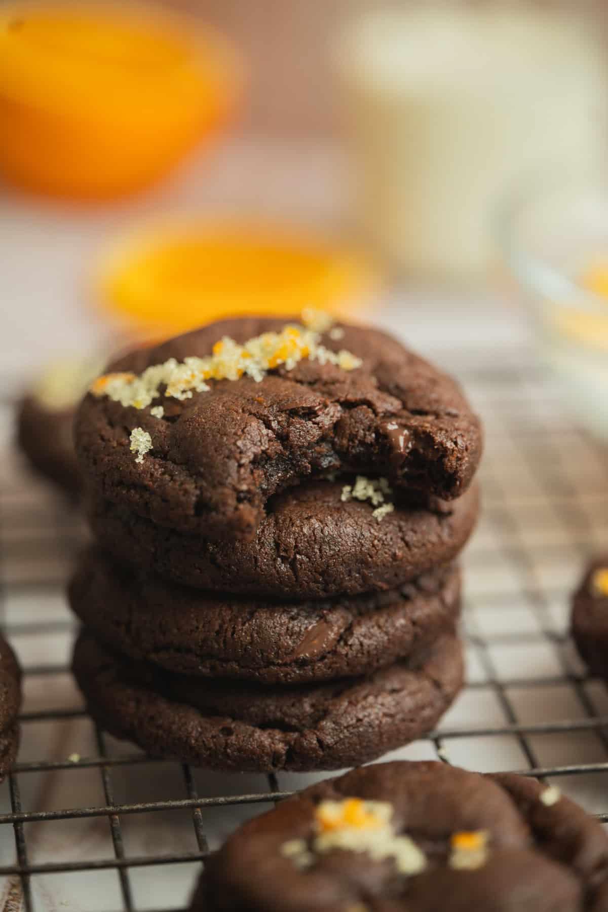 close-up of a stack of freshly glazed chocolate orange cookies arranged artfully on a cooling wire rack