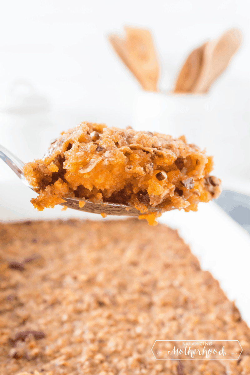 side angle shot of the baked sweet potato casserole, showing the golden butter topping and creamy interior