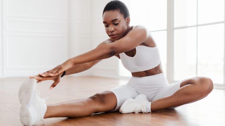 person performing hamstring and quad stretches