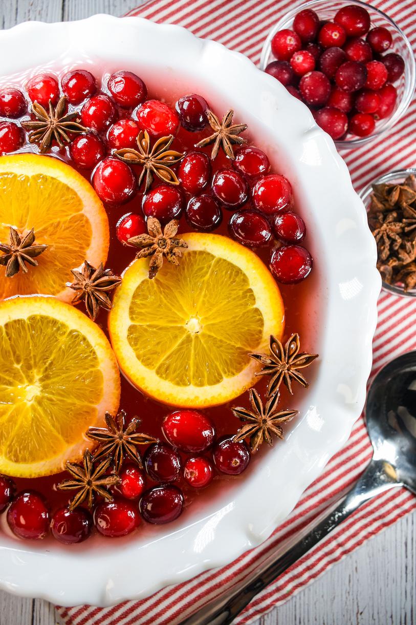 Finished cranberry sauce in a decorative serving bowl, garnished with orange slices