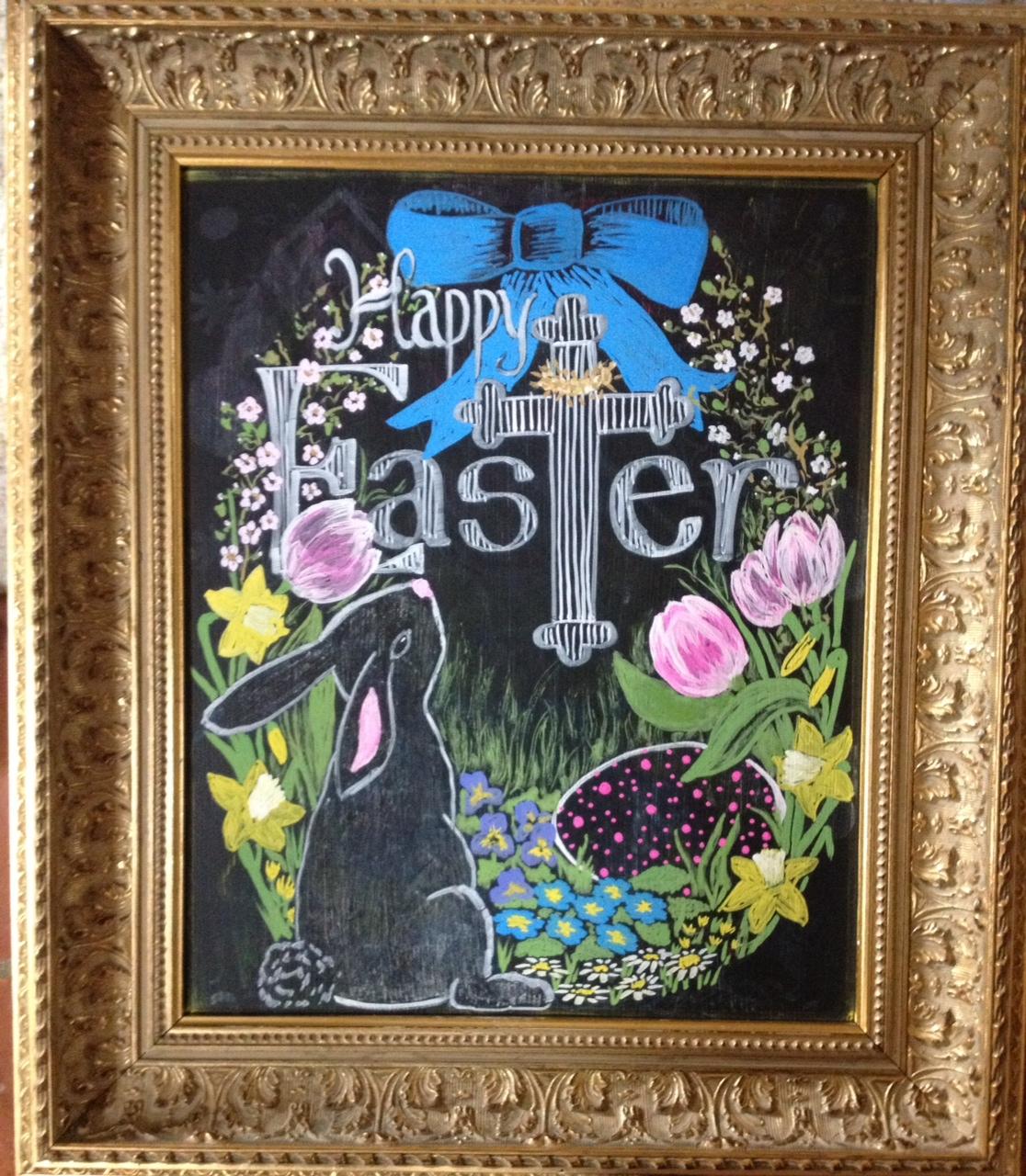 woman drawing on chalkboard easter decorations
