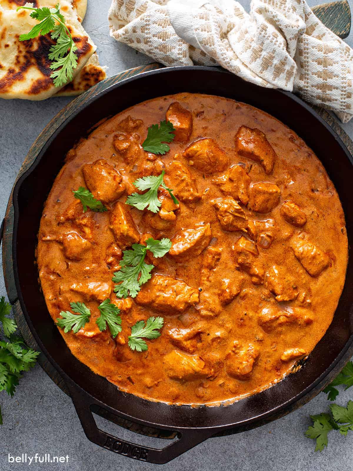 Close-up shot of Chicken Tikka Masala being stirred in a pan