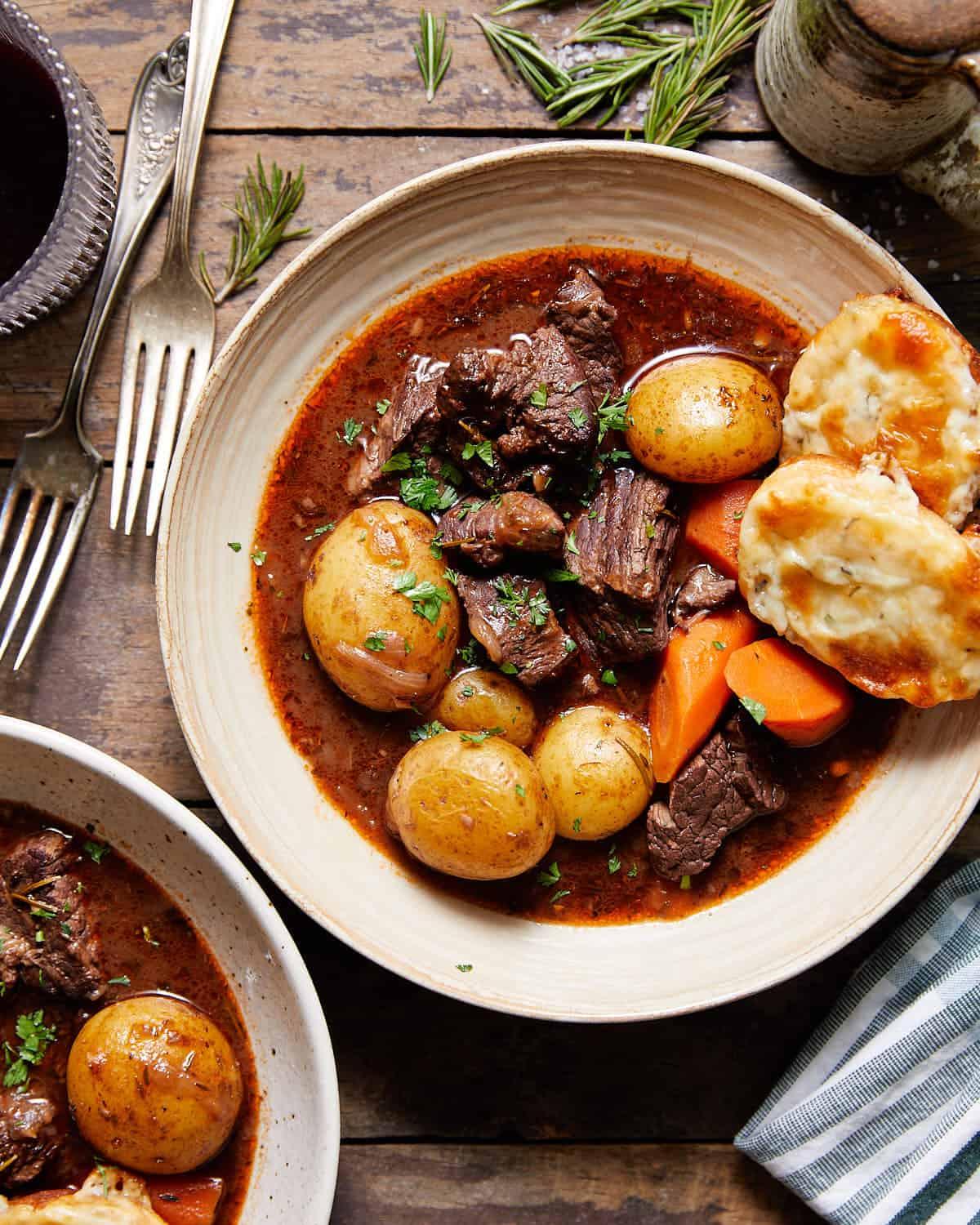 Rustic slow-simmered beef stew in a Dutch oven with crusty bread