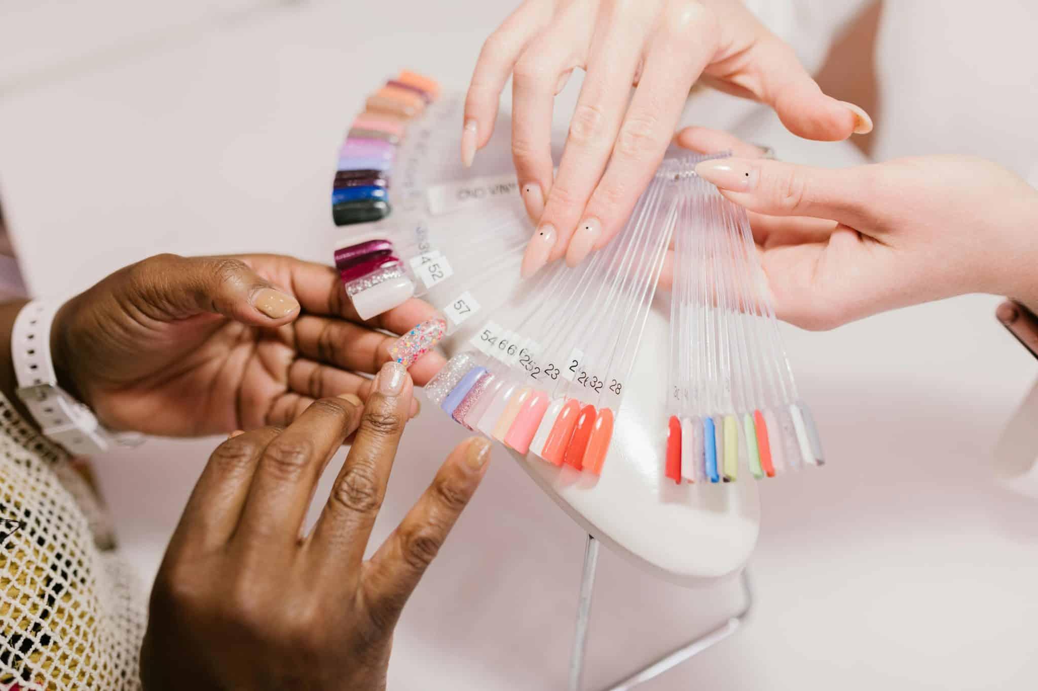 Woman choosing nail polish colors