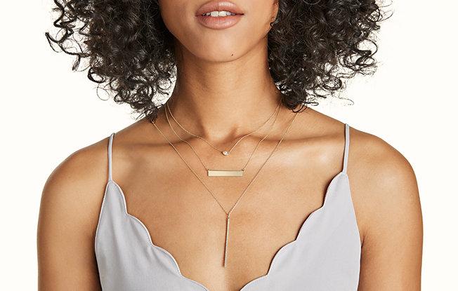 woman wearing multiple layered necklaces