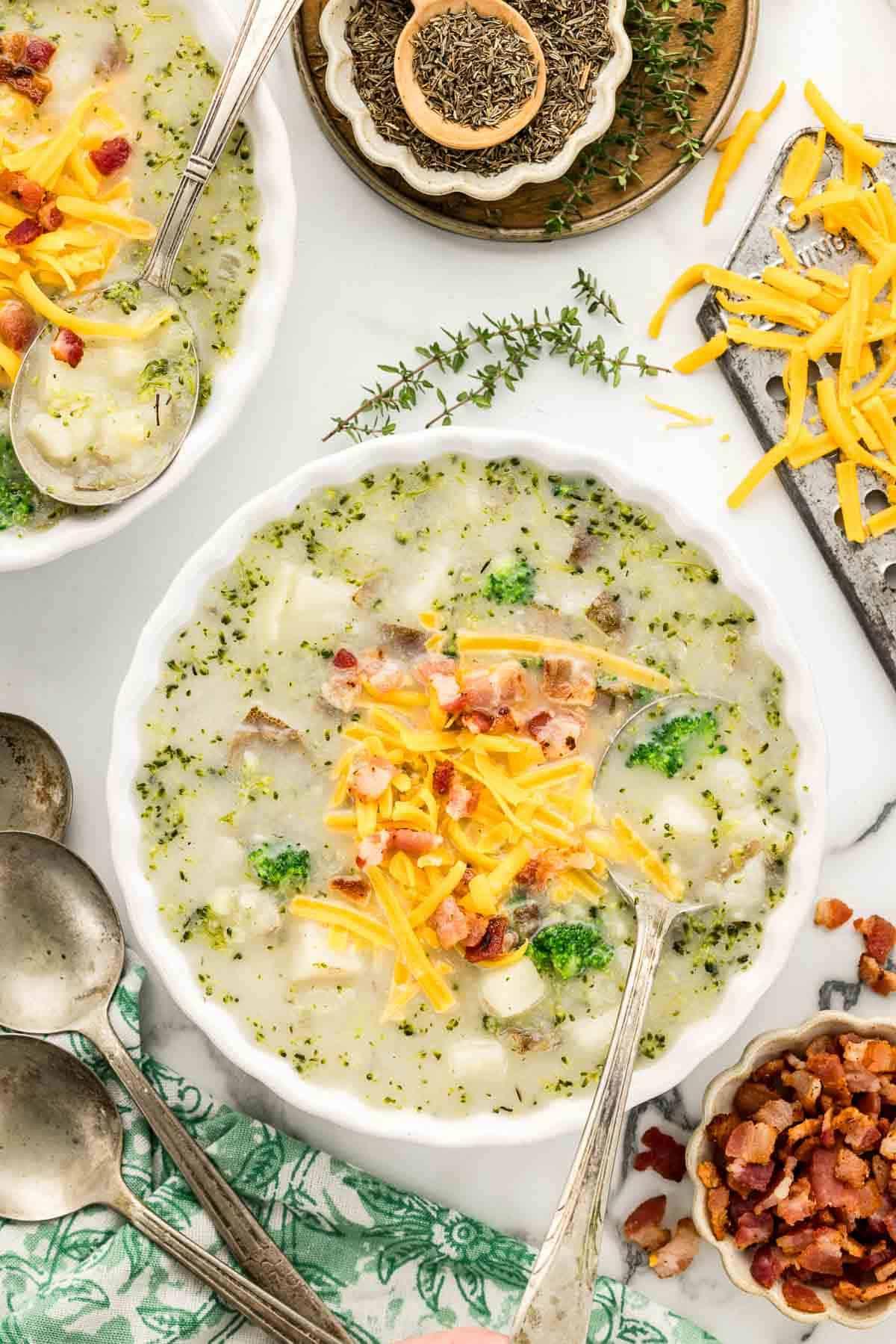 Steaming bowl of potato soup with visible herbs and toppings
