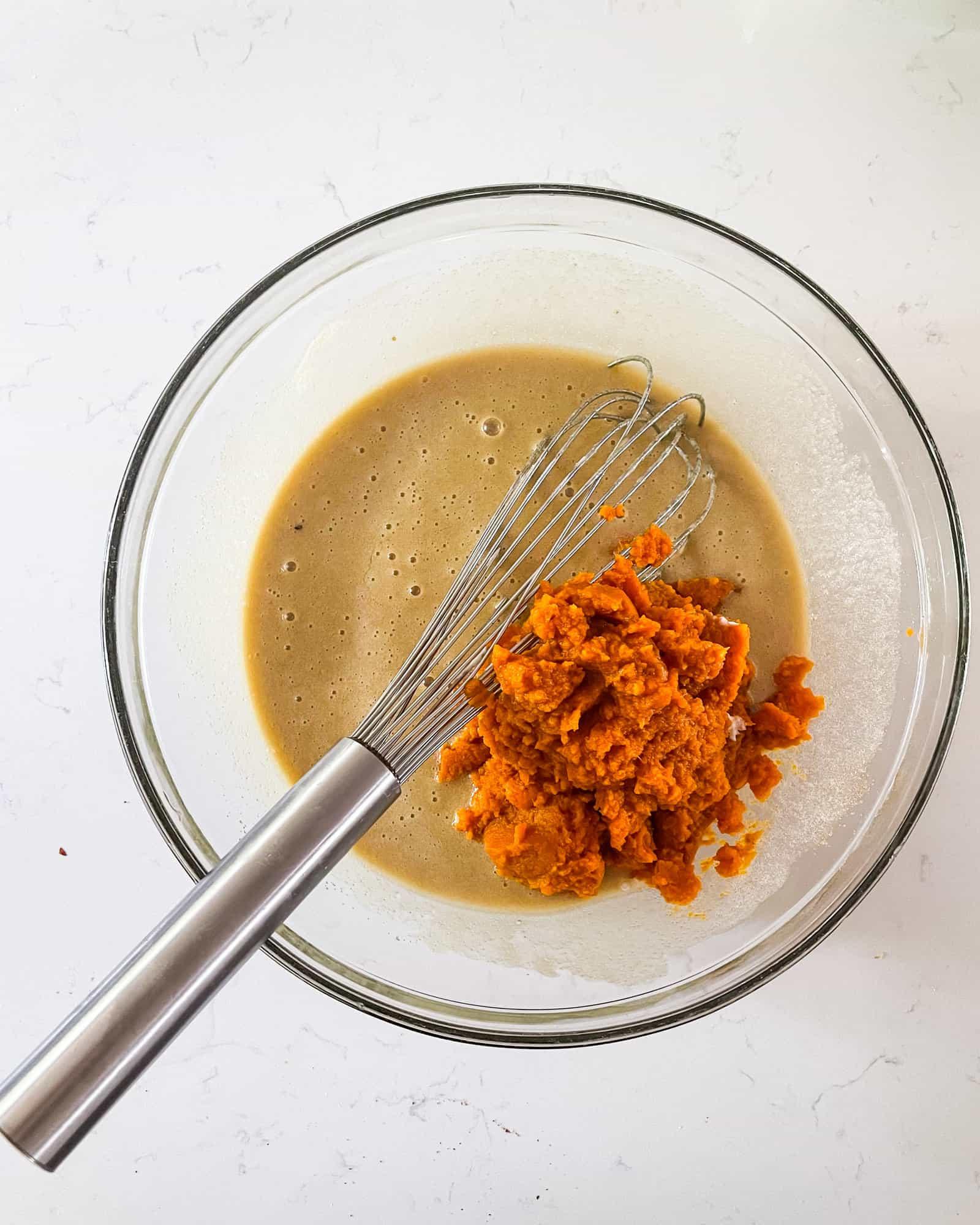 Close-up shot of pumpkin muffin batter being mixed in a bowl