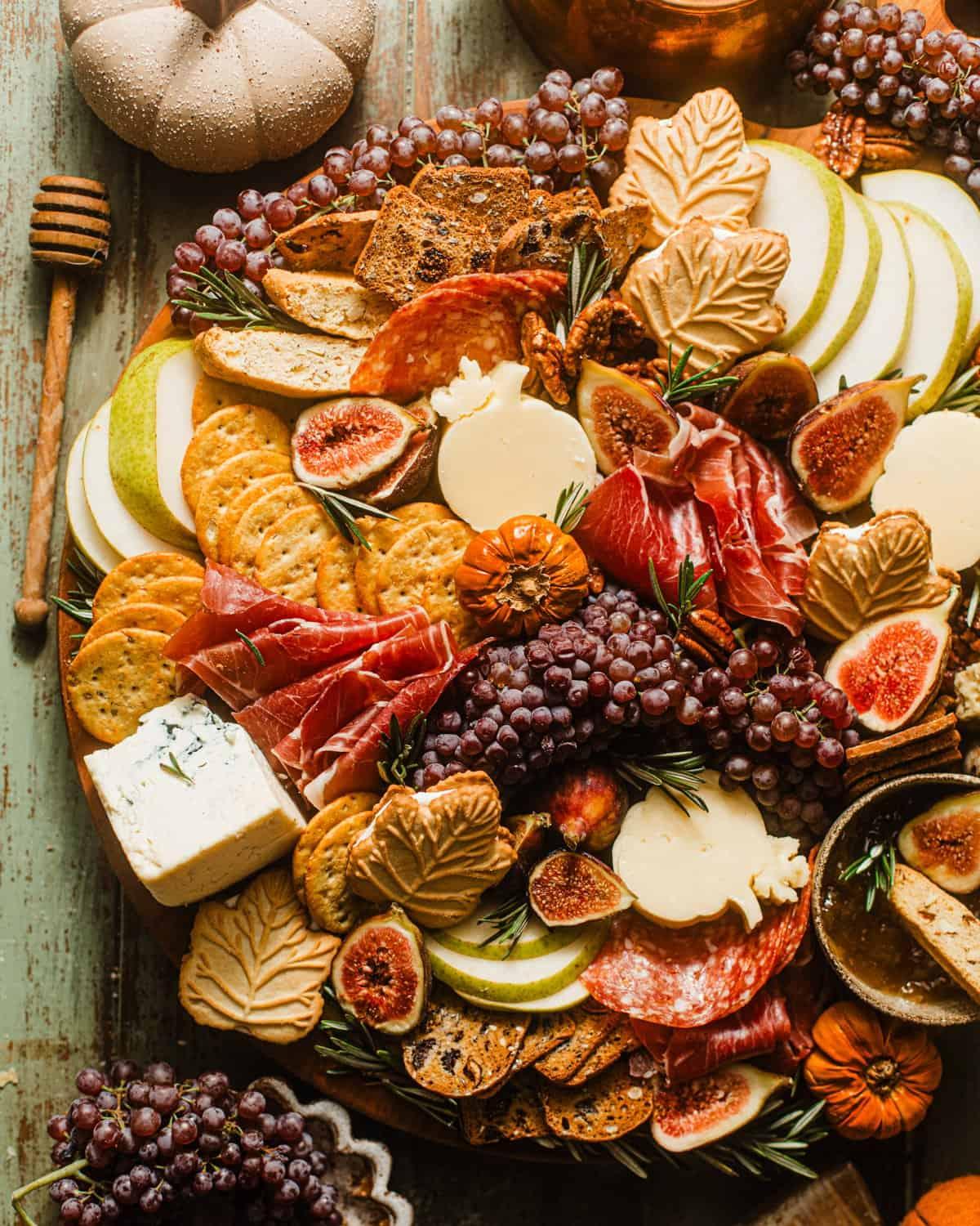 Overhead shot of a beautifully arranged cranberry and walnut charcuterie board