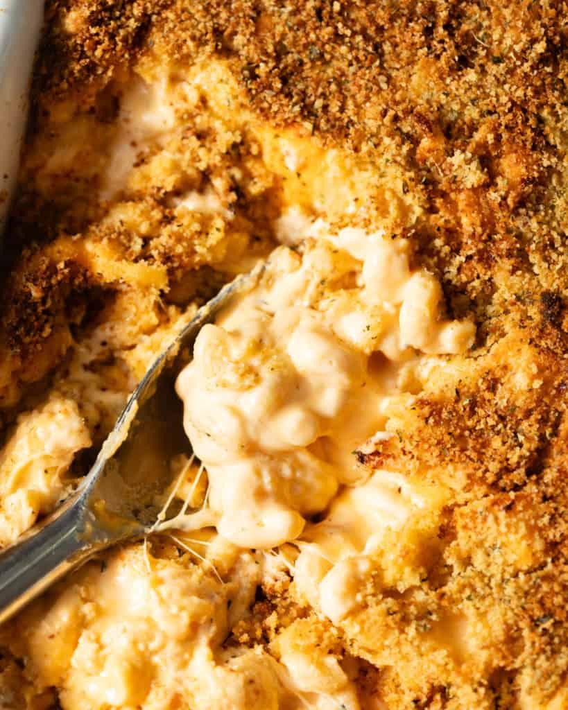 close up of mac and cheese being served from a baking dish