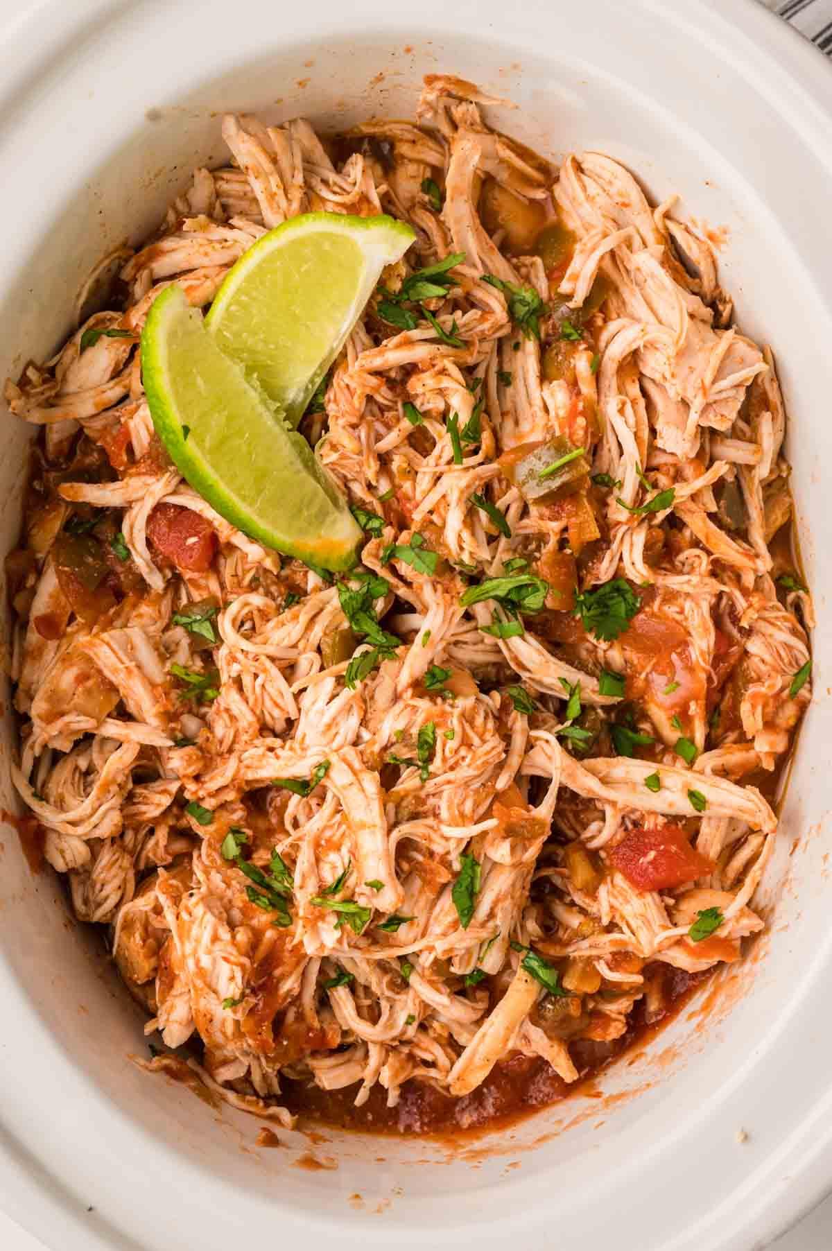 Busy kitchen scene, person looking tired, then slow cooker bubbling with salsa chicken